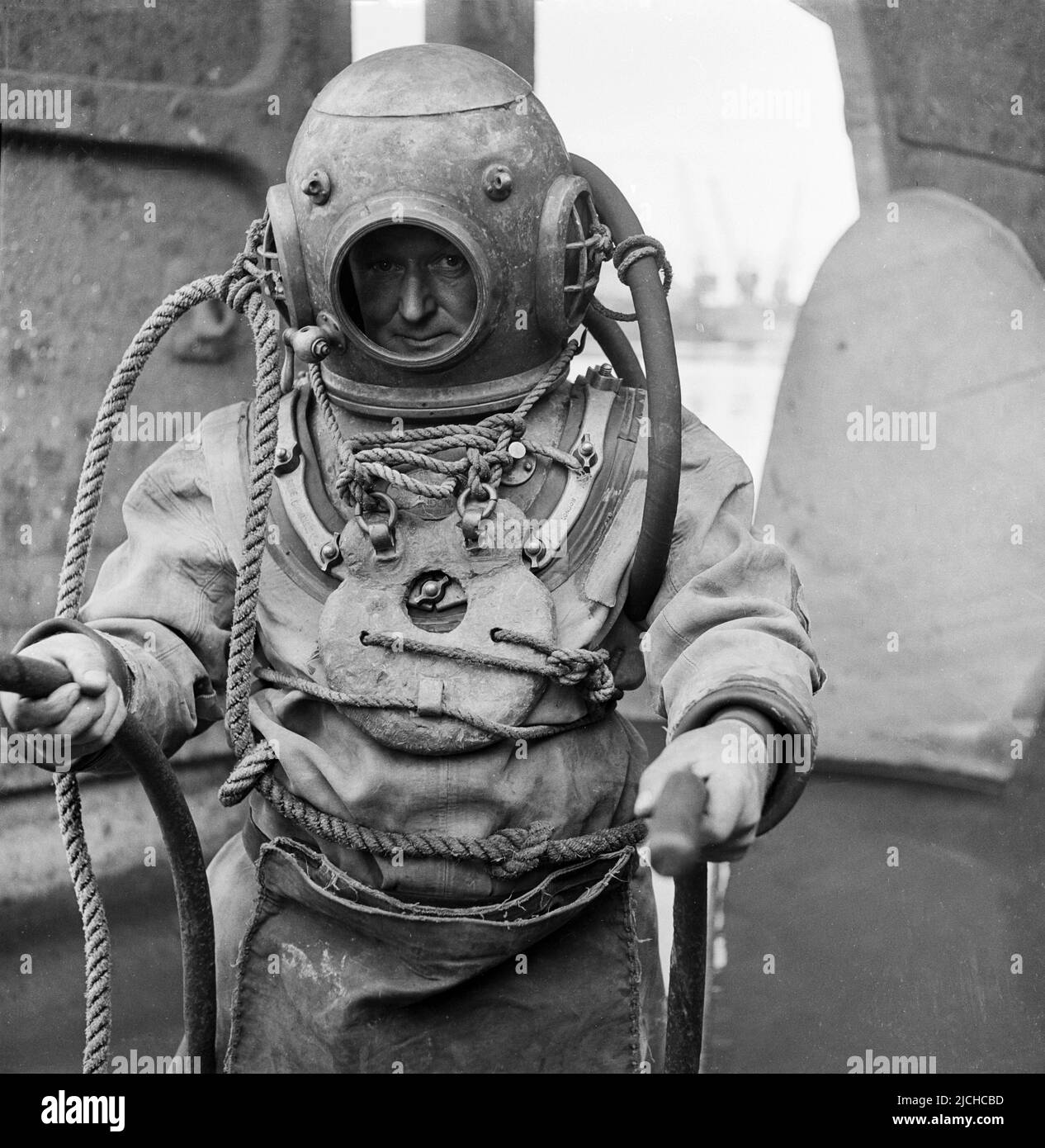1950s-historical-a-deep-sea-diver-in-the-equipment-of-the-day-including-the-heavy-brass-diving...jpg