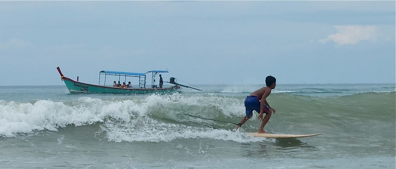 Surfer & longtail boat.jpg