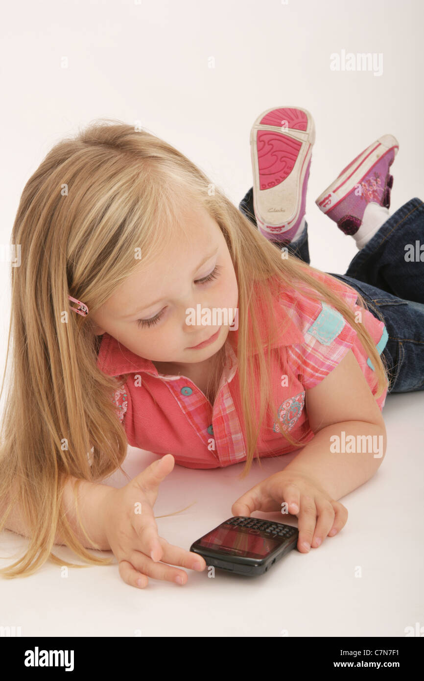 young-girl-lying-down-using-a-smartphone-C7N7F1.jpg