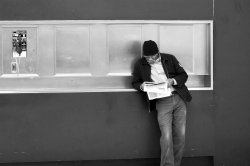 Black Man Reading the Newspaper in the MUNI Subway Station (web).jpg