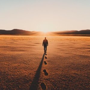 silhouette-man-walking-towards-sunset-desert-plain_1222783-9853.jpg