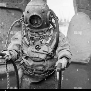 1950s-historical-a-deep-sea-diver-in-the-equipment-of-the-day-including-the-heavy-brass-diving...jpg